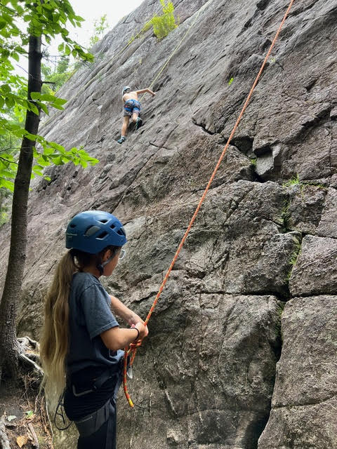 A family climbing together outdoors